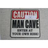 Caution man cave sign