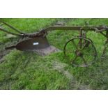 One single furrow horse drawn plough with wheels and guide handles