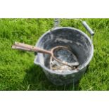 Bucket containing pitchfork tines and chains