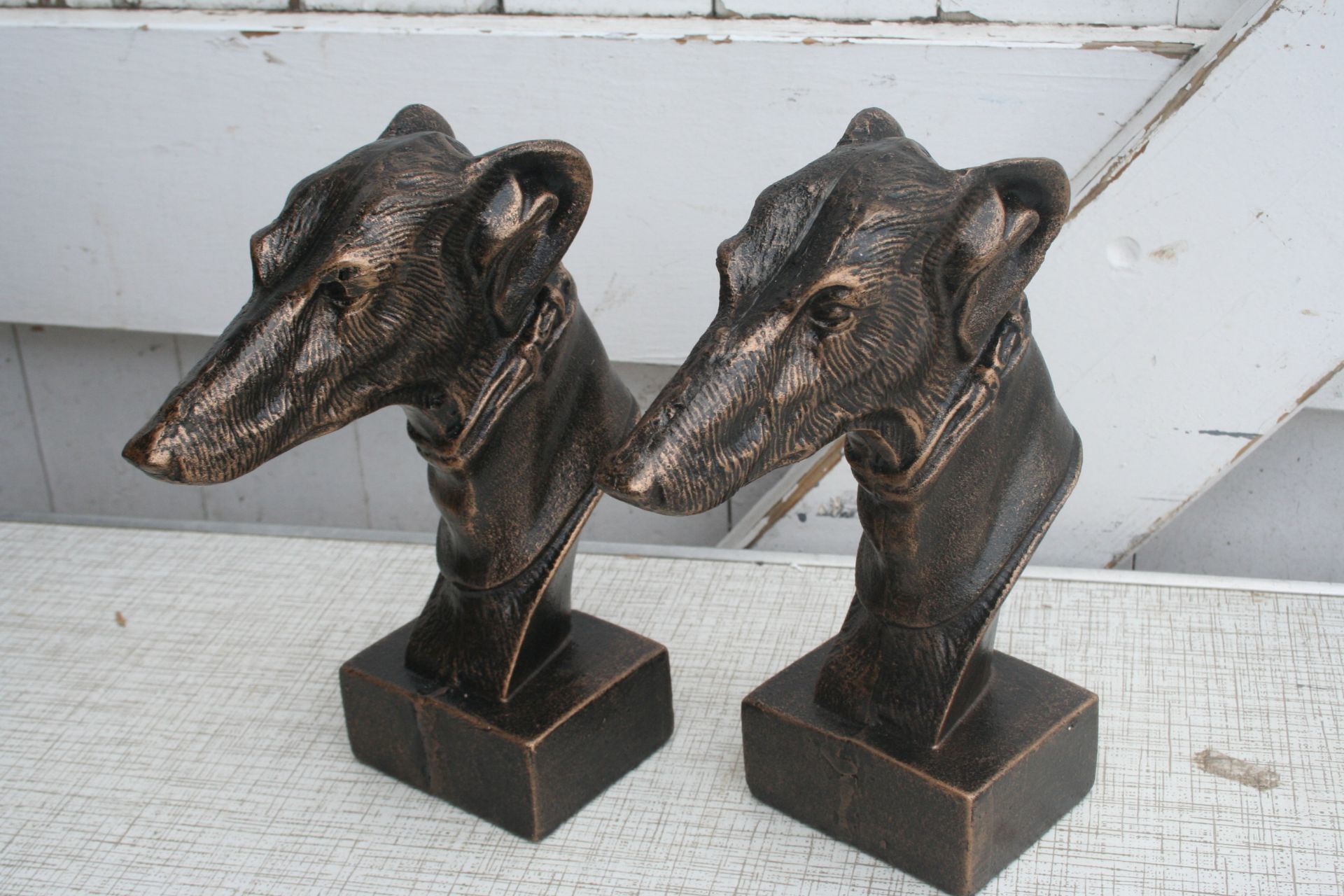 2 cast greyhound heads