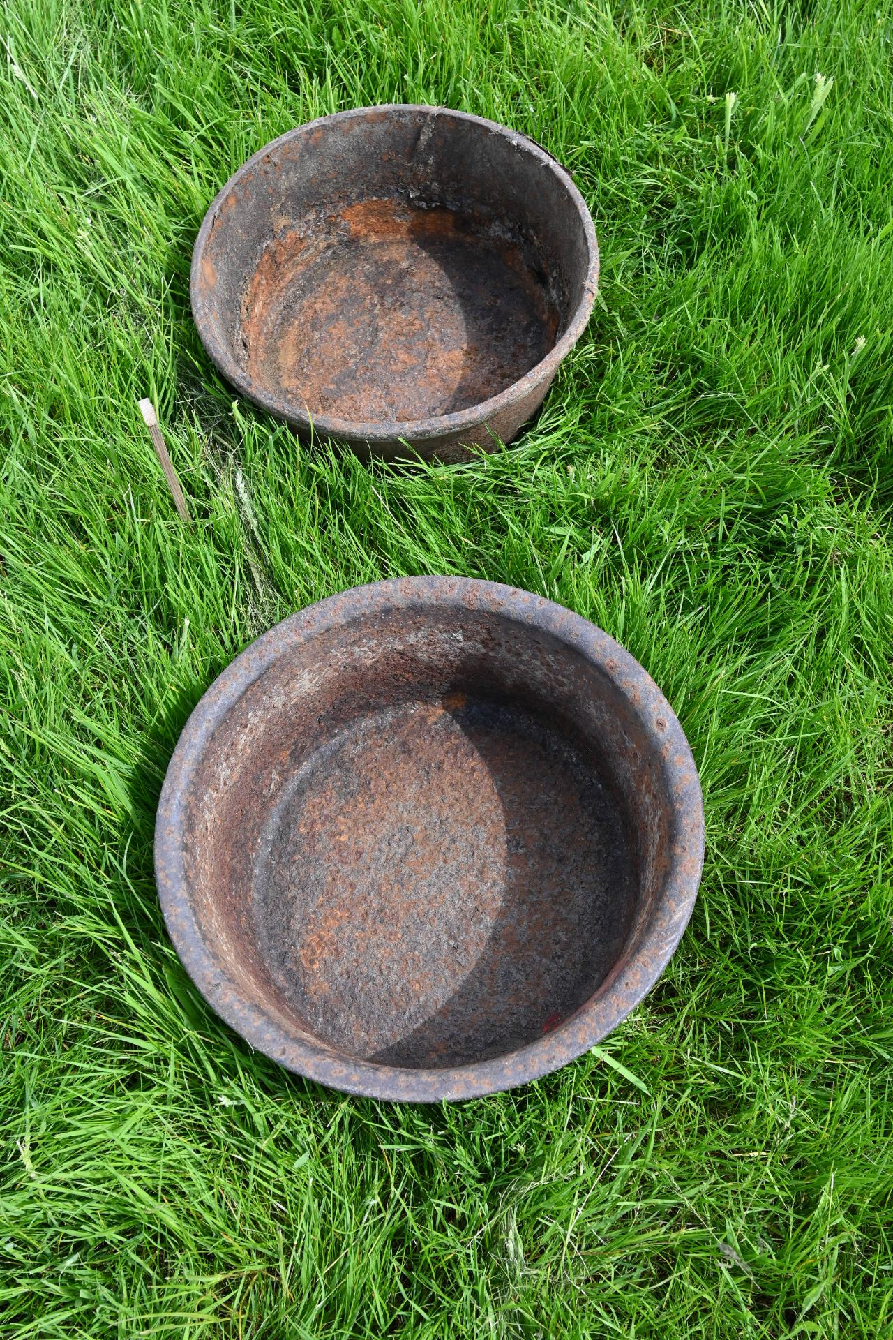 Two cast iron feed bowls