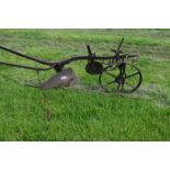 One single furrow horse drawn plough with wheels and guide handles