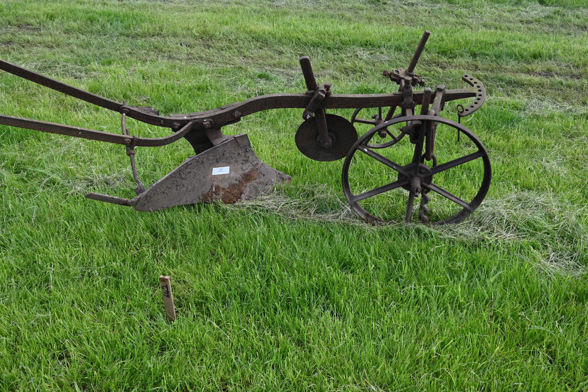 One single furrow horse drawn plough with wheels and guide handles