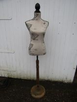 A mannequin on stand made from lamp base