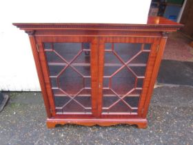 A glazed display cabinet with key and 2 shelves