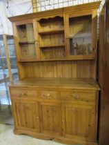 A solid pine dresser with glazed doors to top 136cmW 52cmD 197cmH