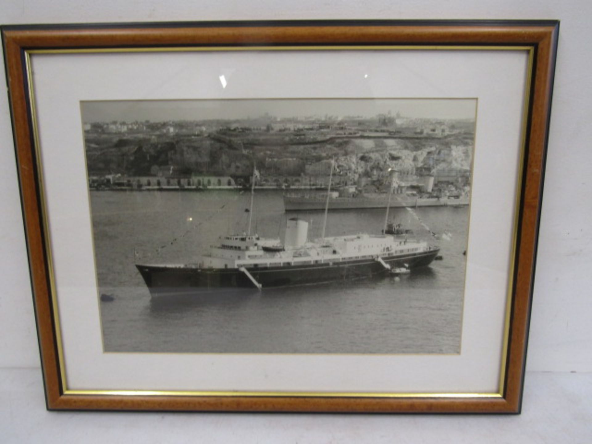 A picture of The Royal Britannia yacht on tour with a picture on verso of the escort 52x40cm