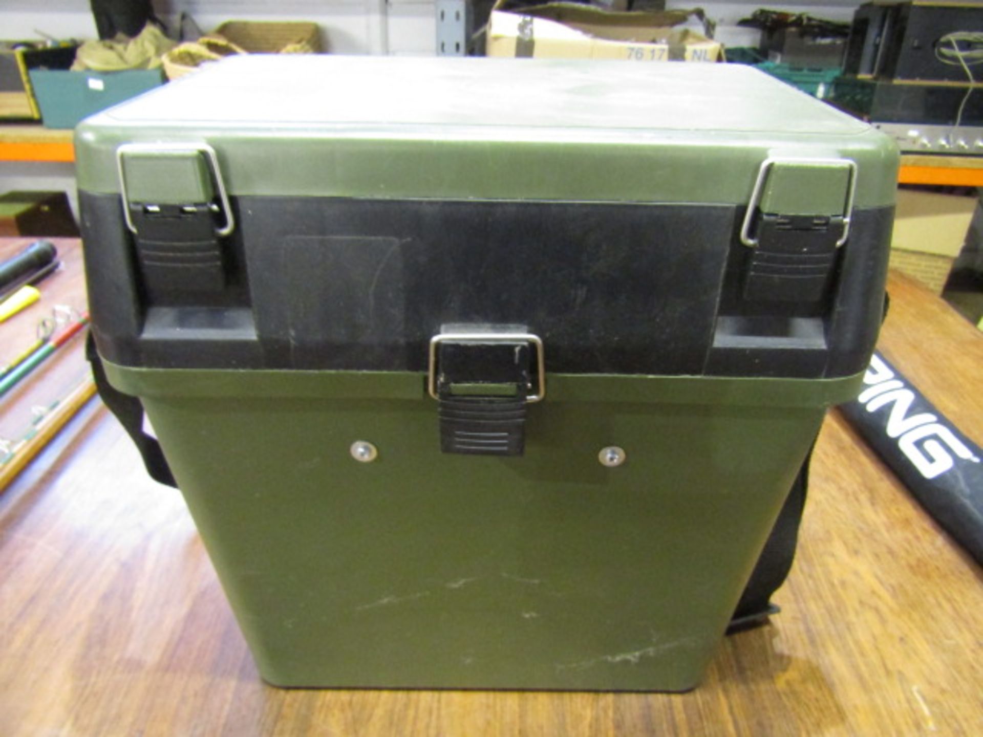 A fishing tackle seat box with compartments and cases inside