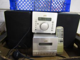 A JVC stereo with speakers and remote plus tapes