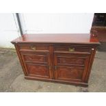 Mahogany dresser base with carved detail to doors and brass handles  H92cm W138cm D49cm approx