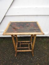A vintage painted bamboo side table