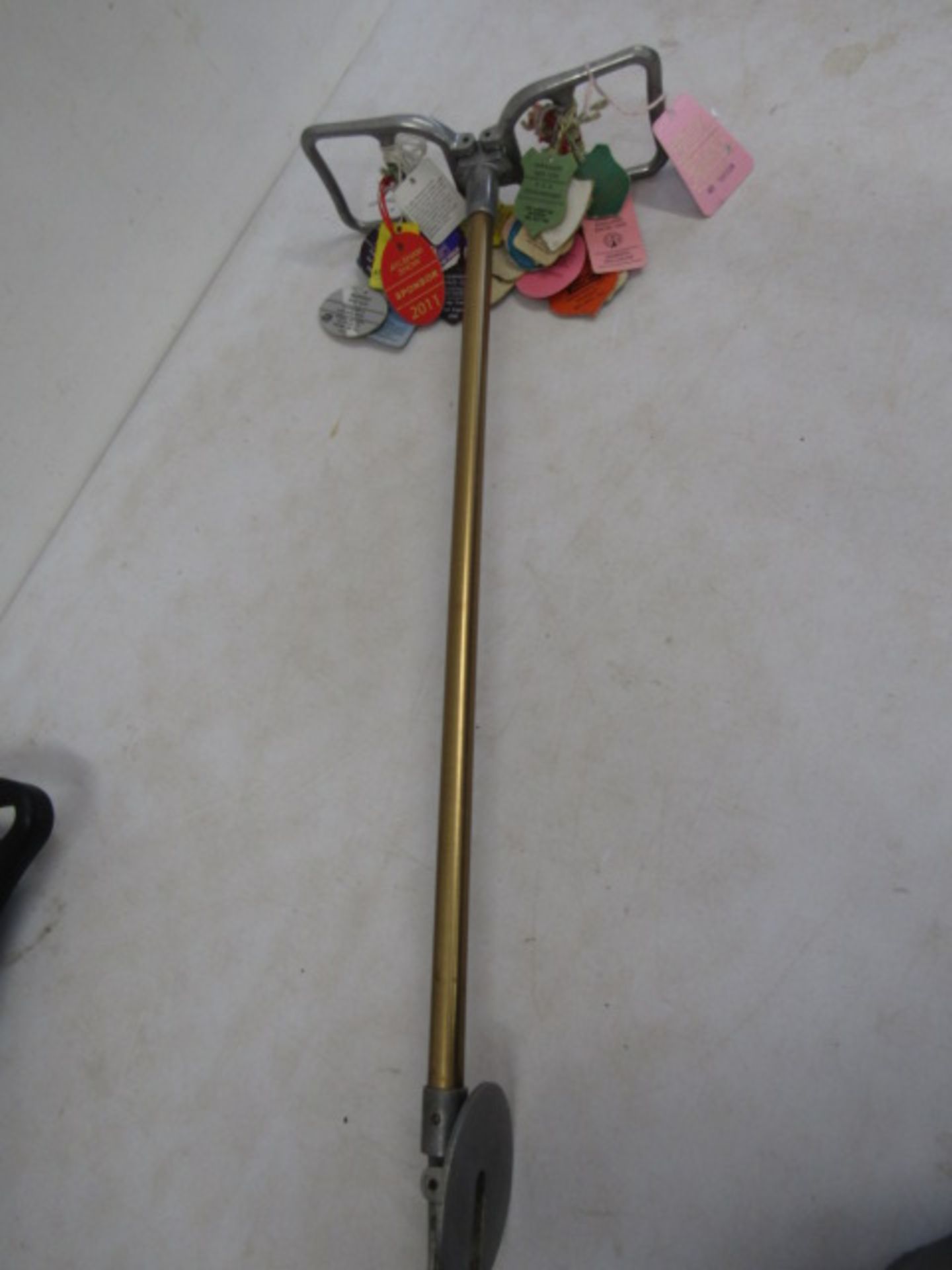 A ladies shooting stick with vintage horse show tags