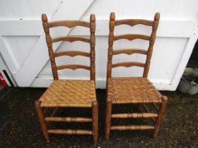 A pair ladder back pine chairs with rush seats