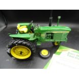 Danbury Mint John Deere model tractor with certs and box one wheel has broken off