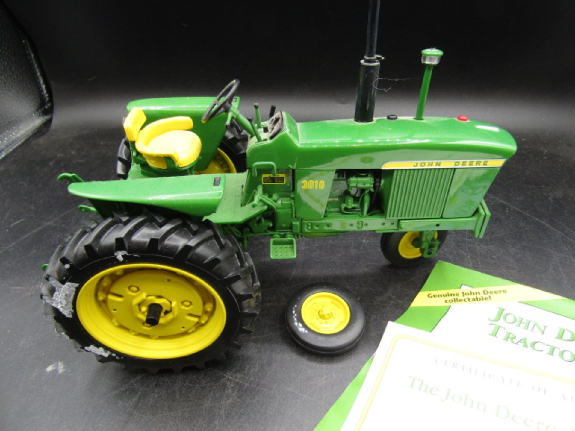 Danbury Mint John Deere model tractor with certs and box one wheel has broken off