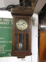 An oak cased wall clock