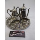 A silver plate coffee, tea pots, sugar bowl, milk jug, sauce boat, grape scissors on a tray