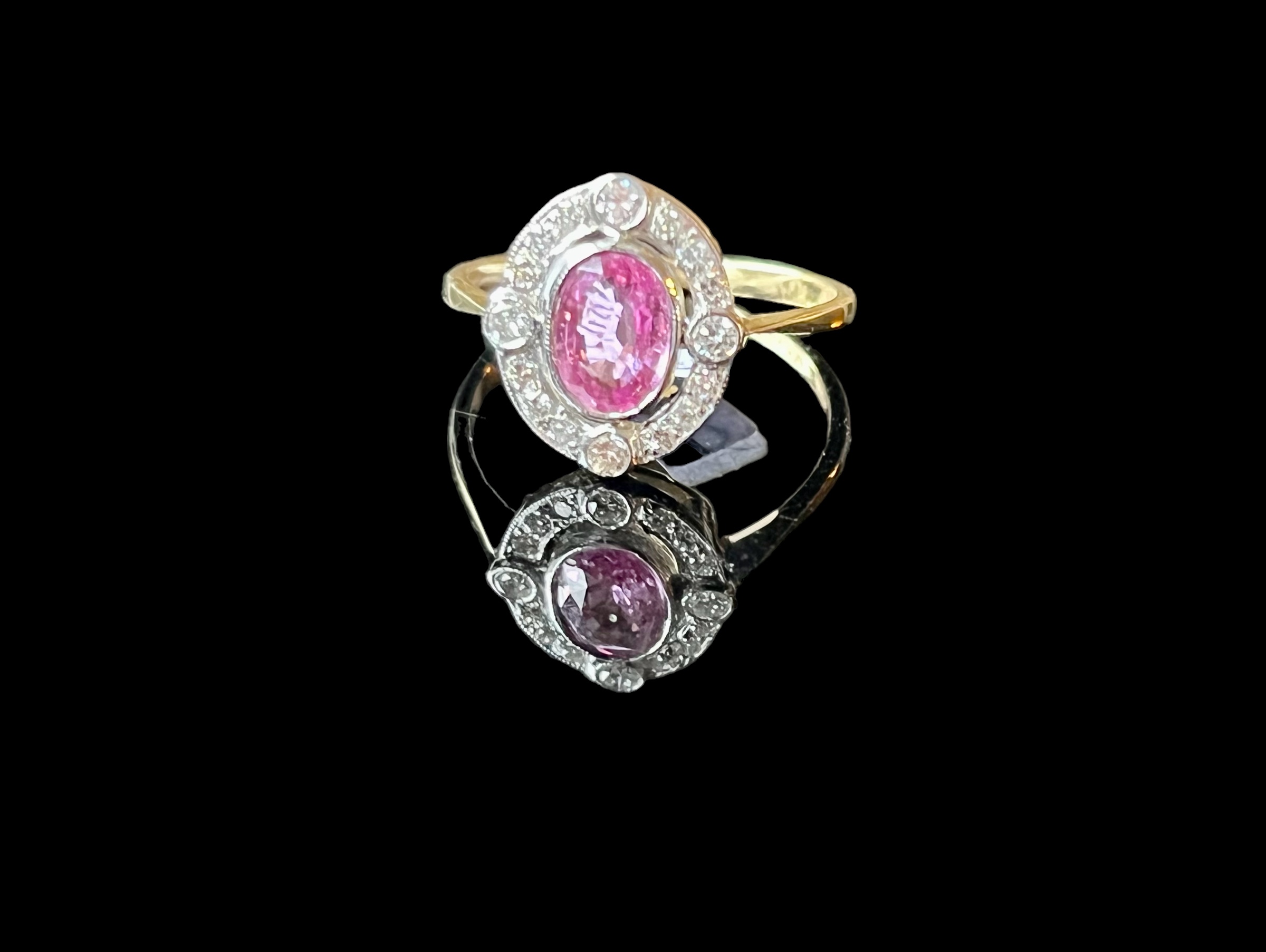 A pink sapphire and diamond ring, set with an oval pink sapphire weighing 0.60 carats, within a - Image 2 of 2