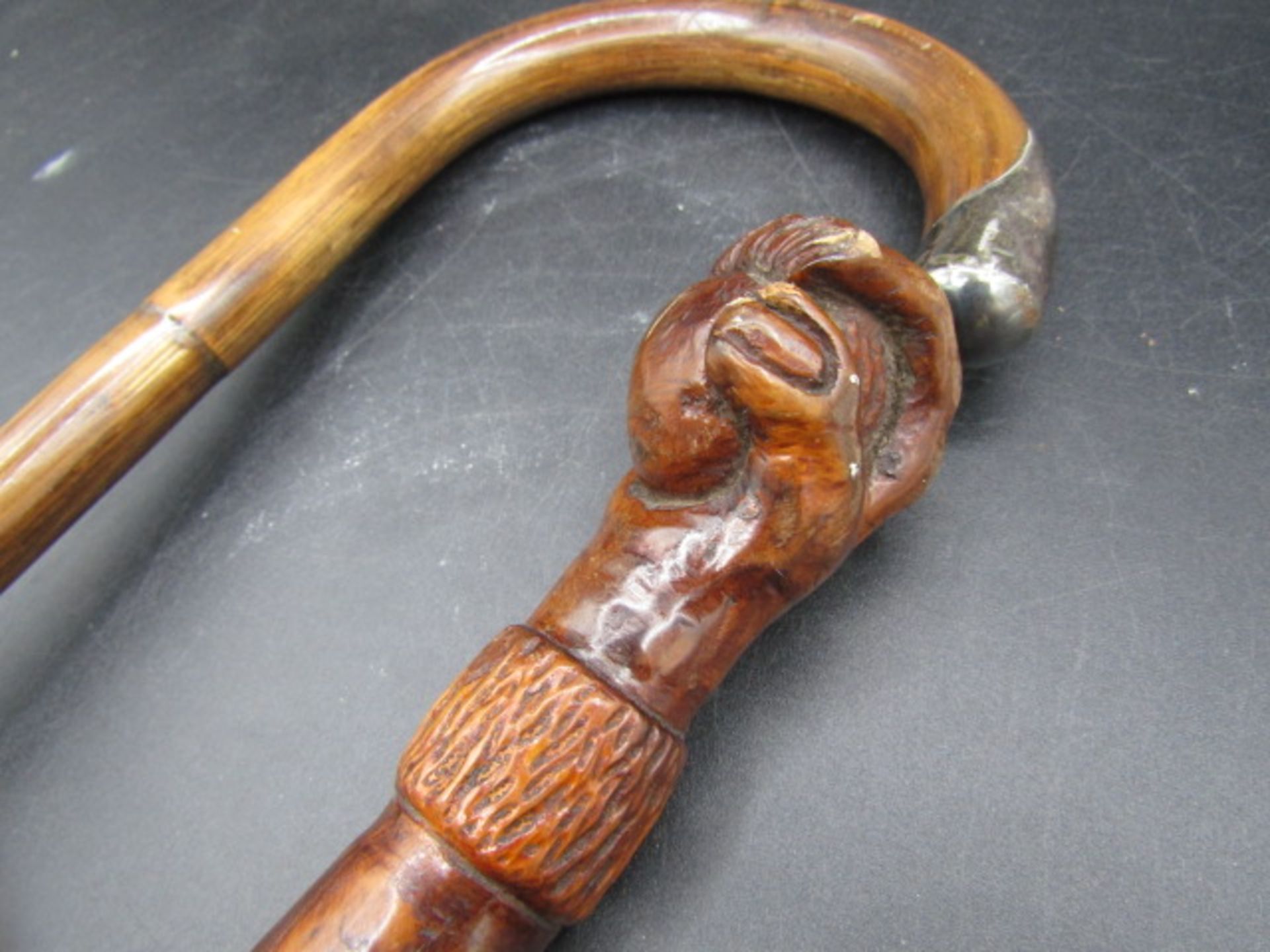 A carved walking cane with a hand clasping a ball with carved ivy down the cane plus a silver tipped - Image 2 of 7