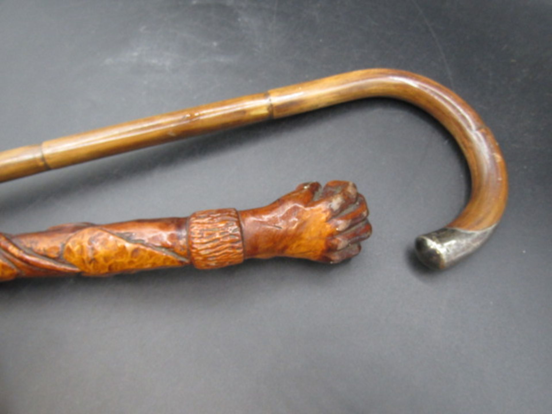 A carved walking cane with a hand clasping a ball with carved ivy down the cane plus a silver tipped - Image 3 of 7