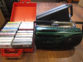 A tape cassette/ radio with a quantity of tapes and some CDs, cassette holders