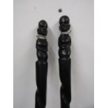 A pair of spears with carved busts 122cmL