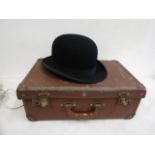 A vintage Bowler hat and suitcase