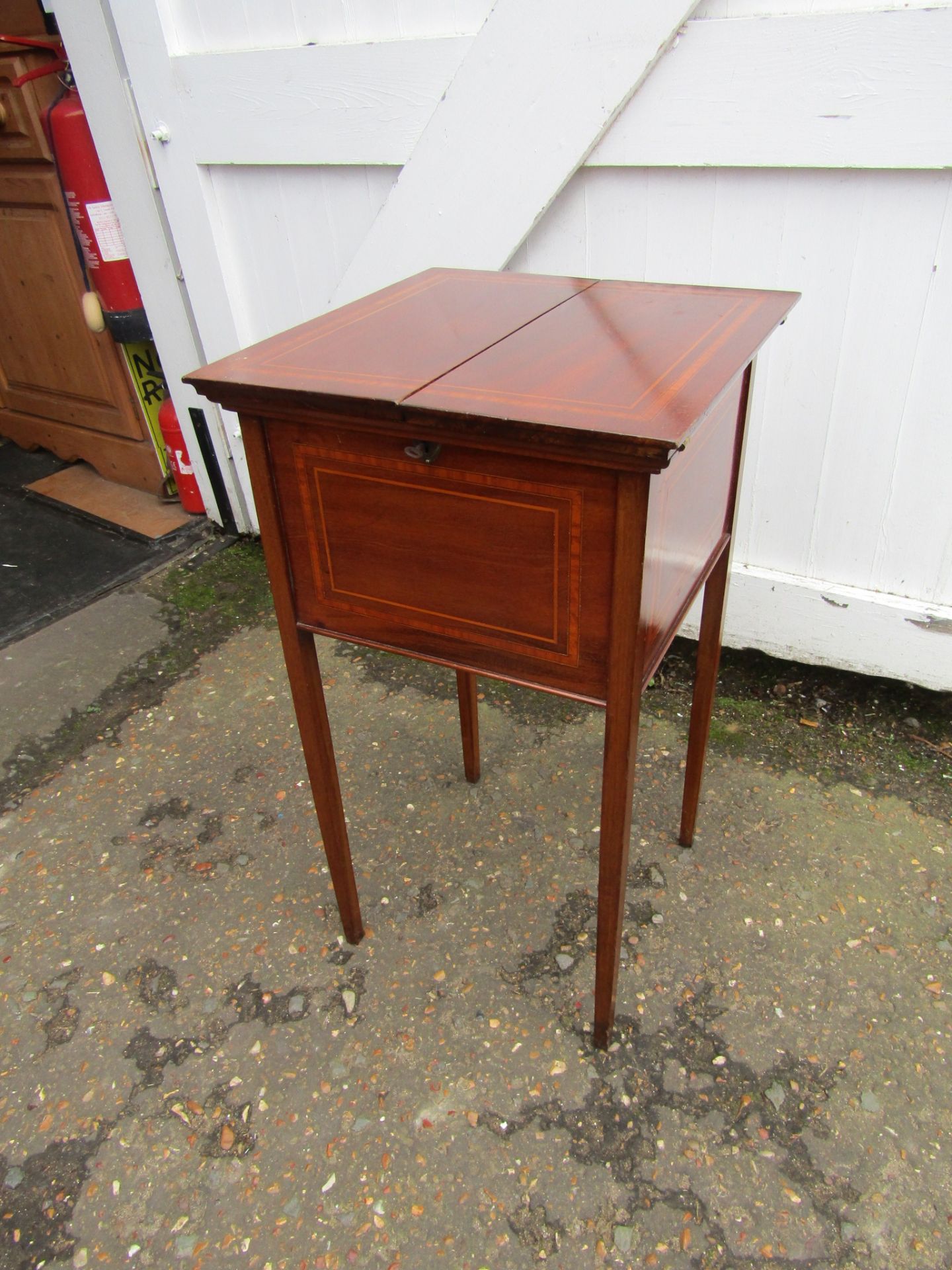 Mahogany veneered inlaid sewing box on castors