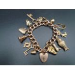 9ct rose gold heart lock charm bracelet marked on each link, has 15 different charms all but 3 are