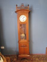 Early 20th Century Hamburg  American Clock Company longcase clock with weights and pendulum in oak