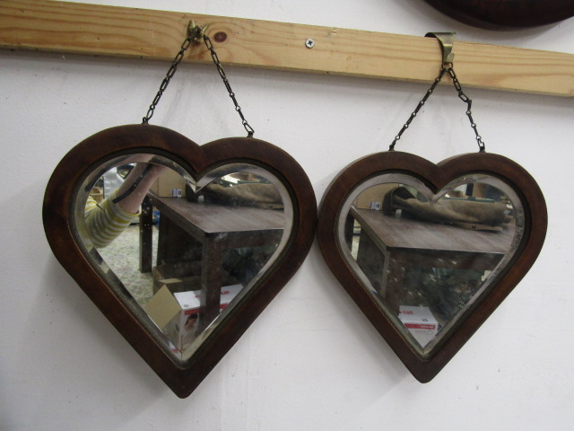 A pair heart shaped bevelled mirrors with oak? frames 28x30cm