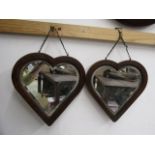 A pair heart shaped bevelled mirrors with oak? frames 28x30cm