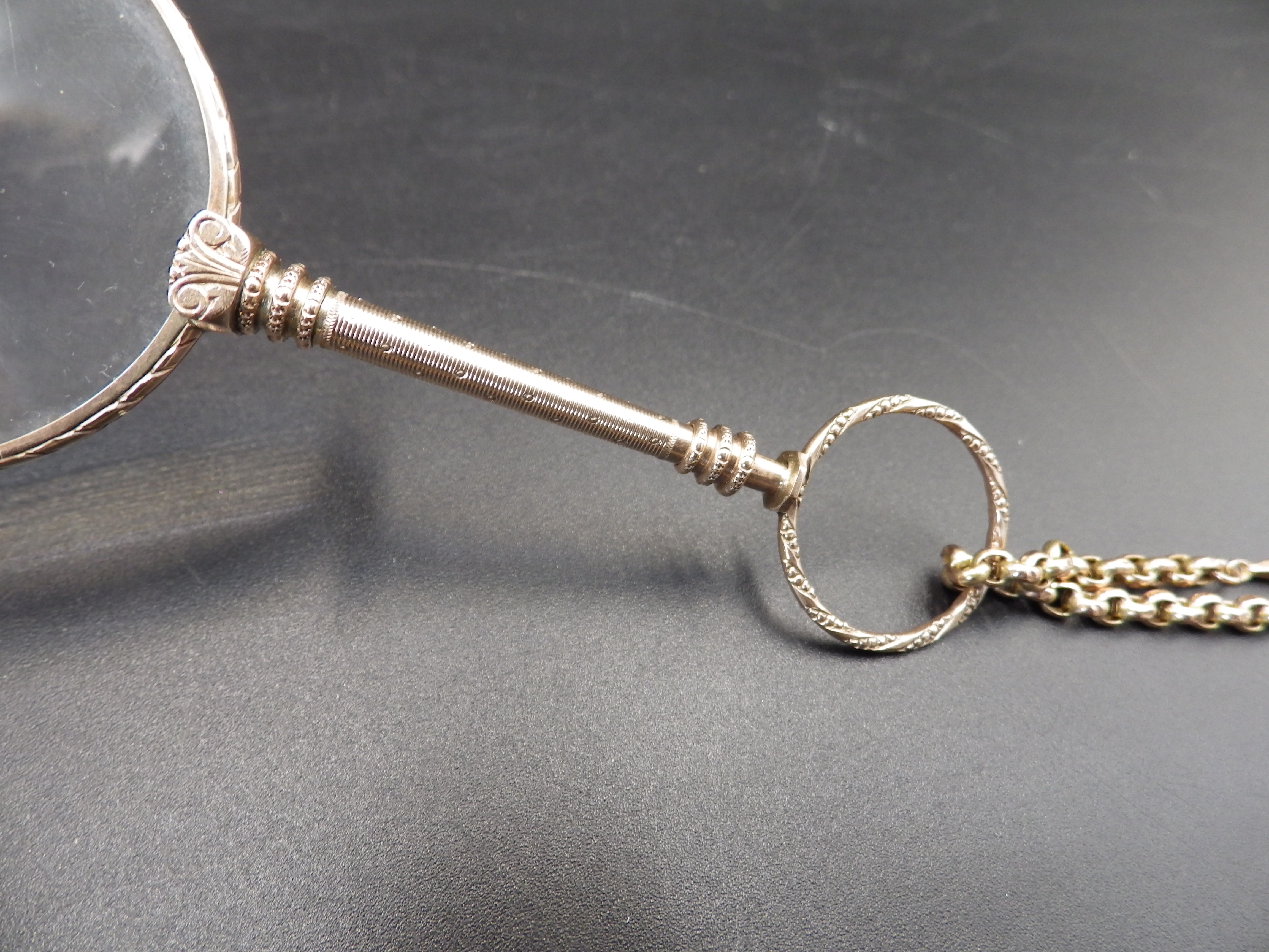 A double lorgnette marked 9 kt, on a gold chain marked 9 ct with decorative sphere detail, the chain - Image 2 of 6