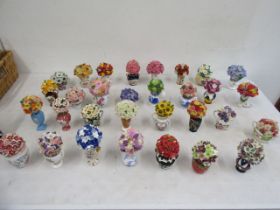 A collection 31 ceramic posies, stamped on base with symbol, all look to be in styles copying well