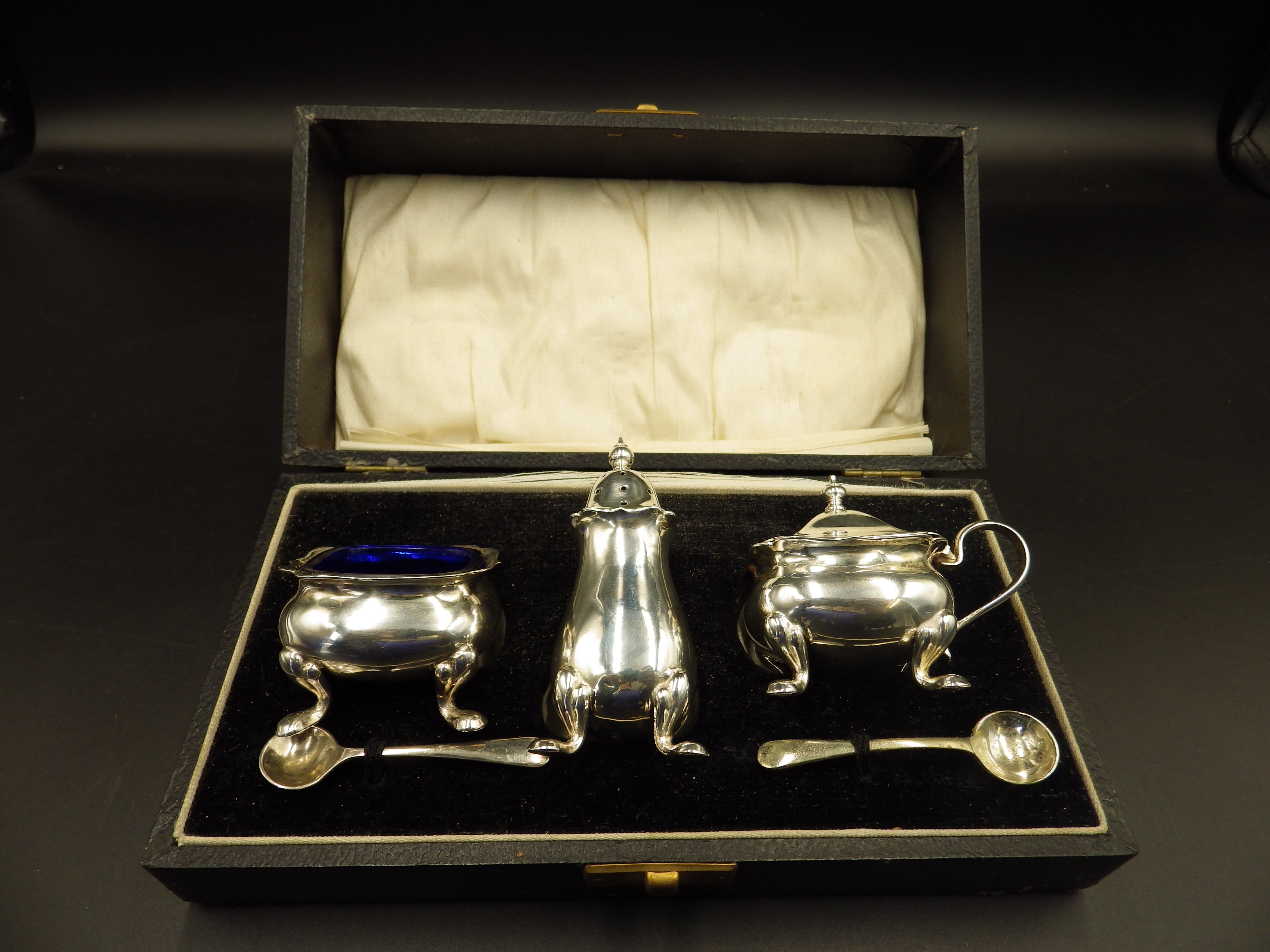 Cased, silver plated cruet set with blue glass liners