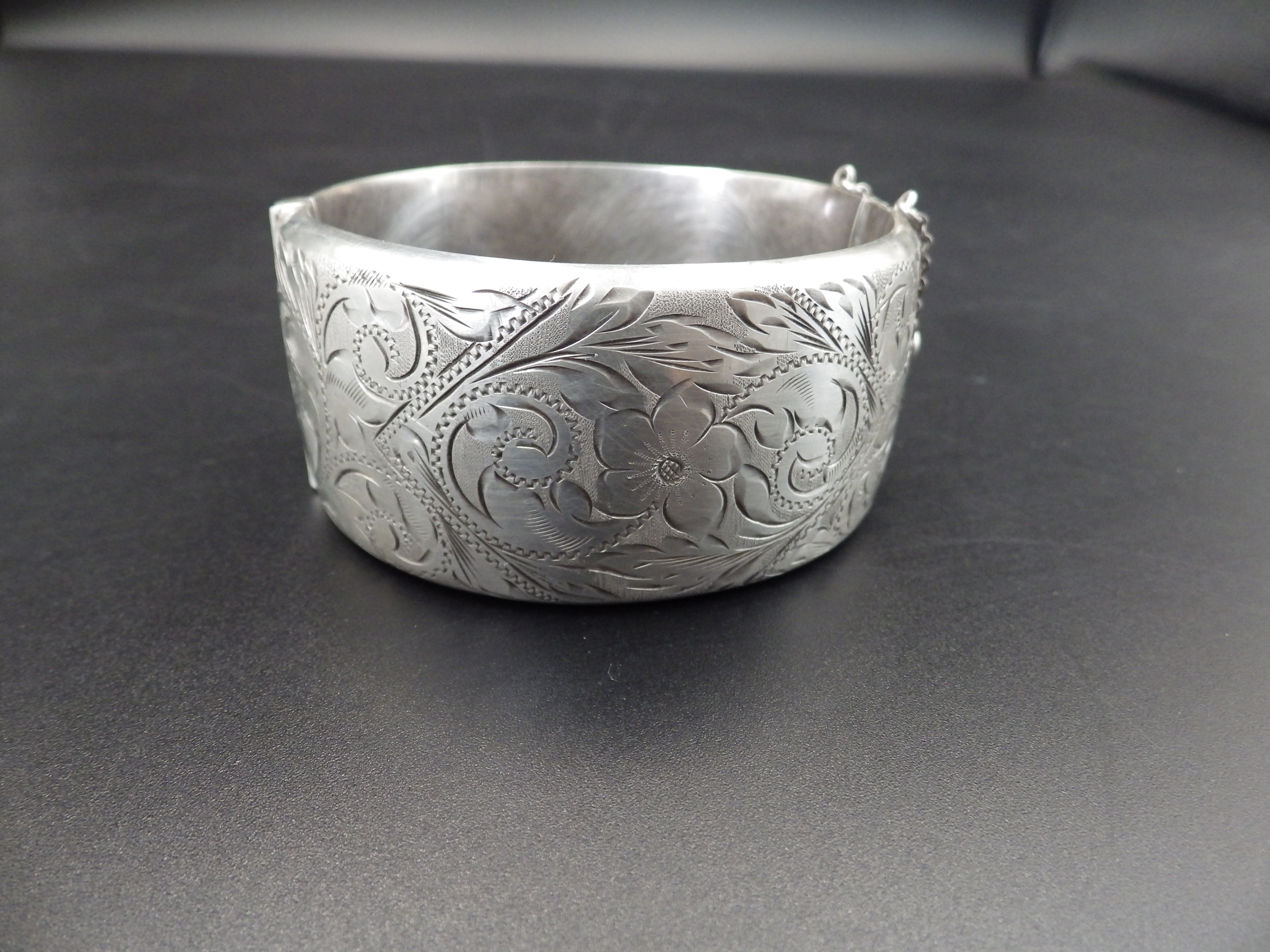 A silver hallmarked hinged bangle with safety chain (Birmingham 1966 by Ronex) 49.18g total weight. - Image 3 of 4