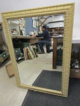 A large bevelled mirror 108x74cm