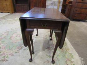A mahogany gate leg table with drawer