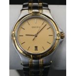 Gucci bi-coloured quartz wristwatch ref. 9040m, the gold tone dial having batton indices and date