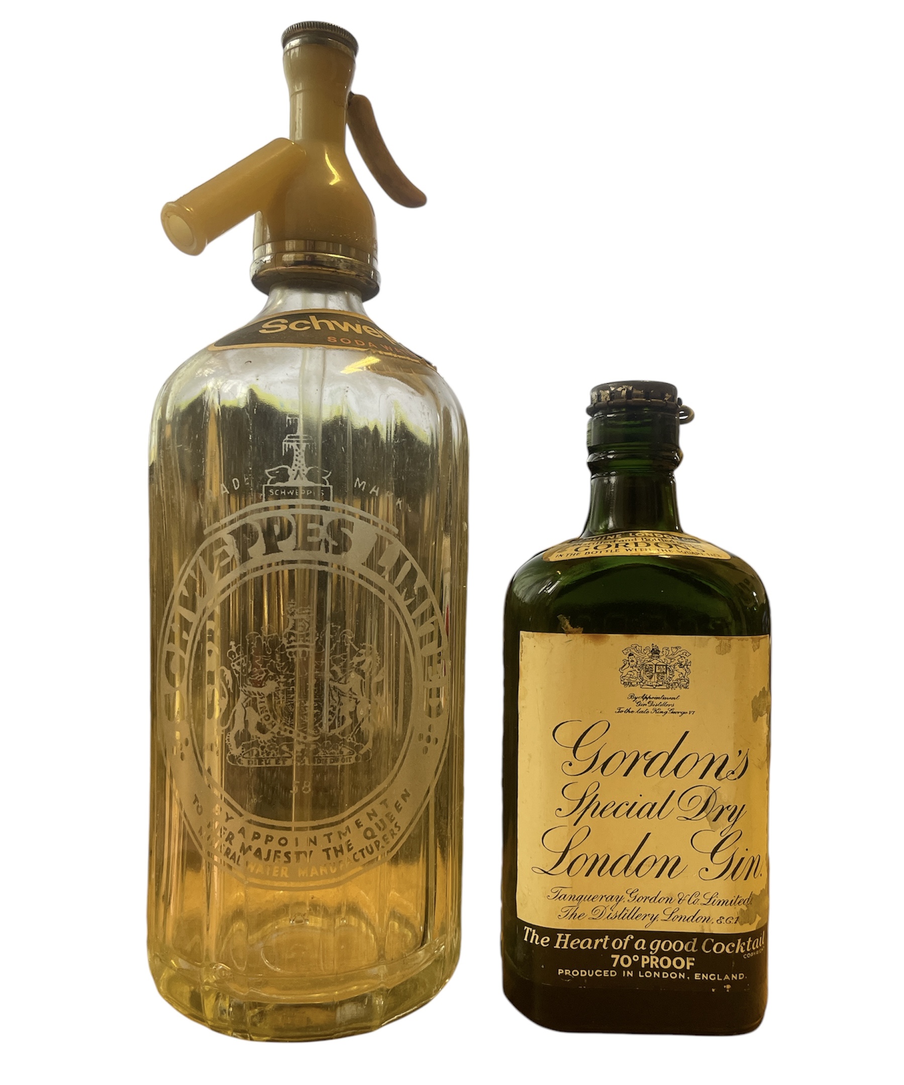 Two vintage bottles to include a Schweppes Soda Water d  espenser and a Gordon's Gin bottle with a