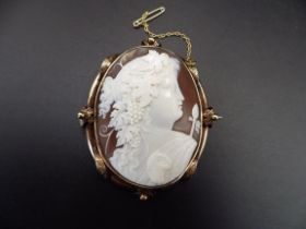 Late Victorian carved shell cameo brooch edged in rose gold, depicting a bacchante in profile,