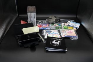 Nintendo DS Lite together with 8 assorted games incl Professor Layton trilogy with charger