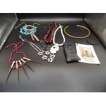 A box containg tribal themed jewellery and 'Witchdoctor' fortune telling bones in a pouch