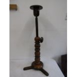 A milliners hat stand with extending top