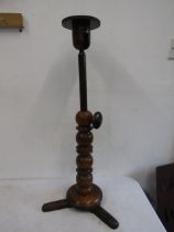 A milliners hat stand with extending top