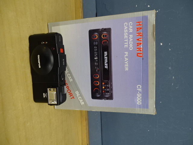 Boxed Harvard car radio cassette player and Olympus camera from a house clearance