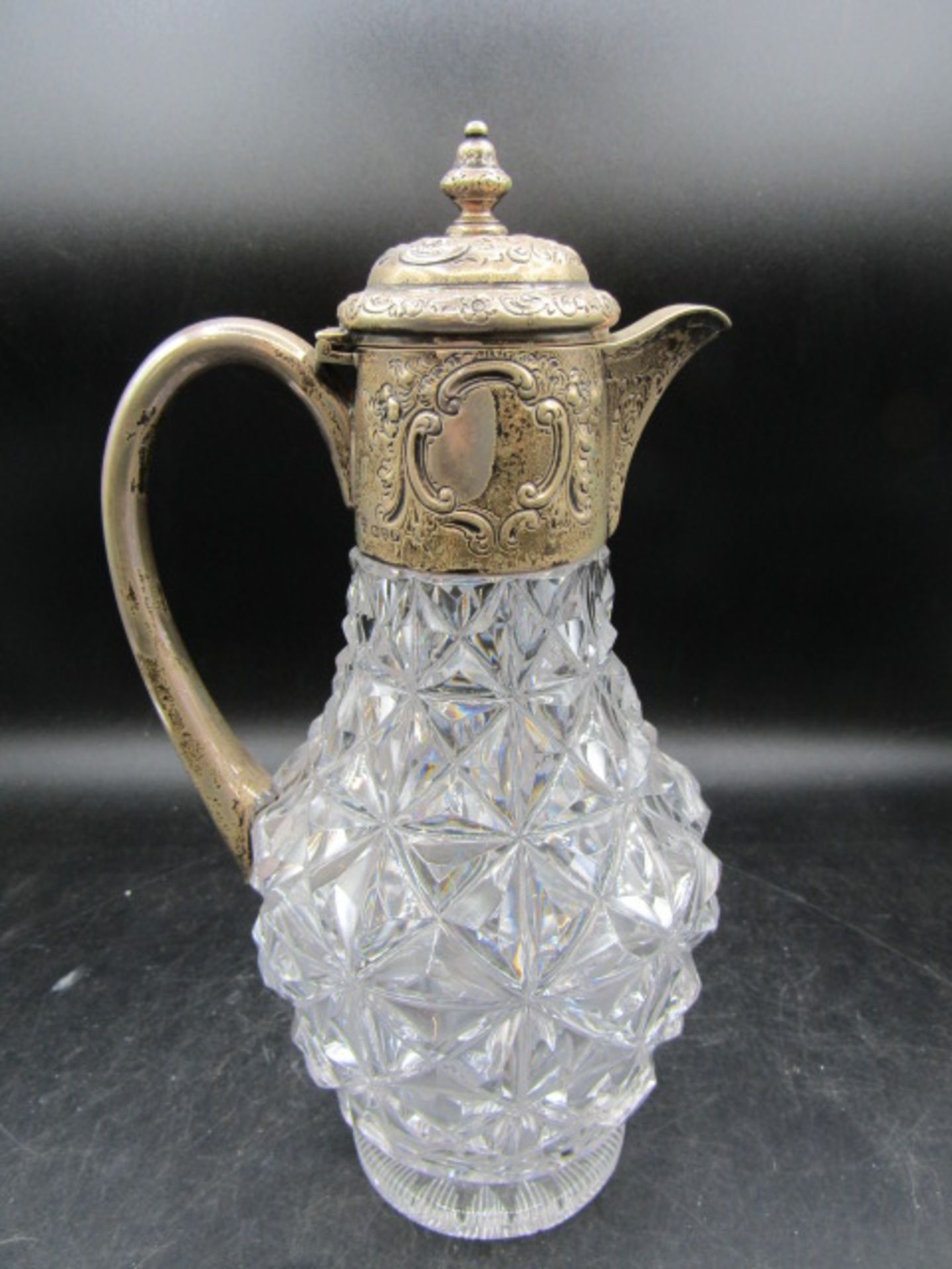 A cut glass silver embossed collar claret jug, hallmarked Chester 1913 Haseler Brothers