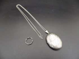 A silver hallmarked locket on a chain (Birmingham 1978) and a silver ring size M, total lot weight