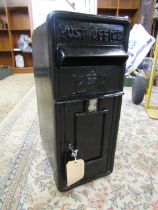A cast iron post box with key