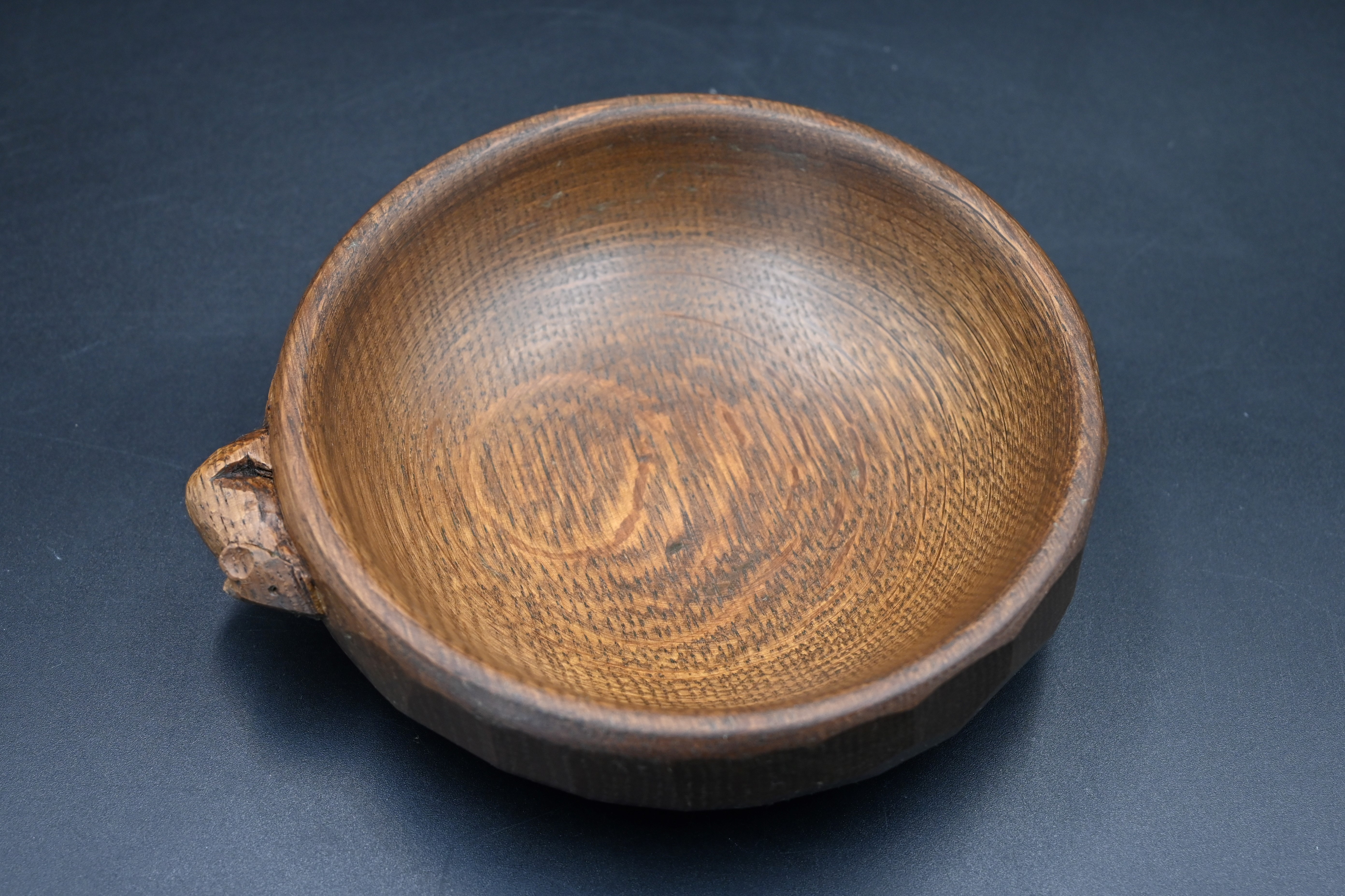 Mouseman - an oak bowl with an adzed exterior finish with a mouse signature, by the workshop of